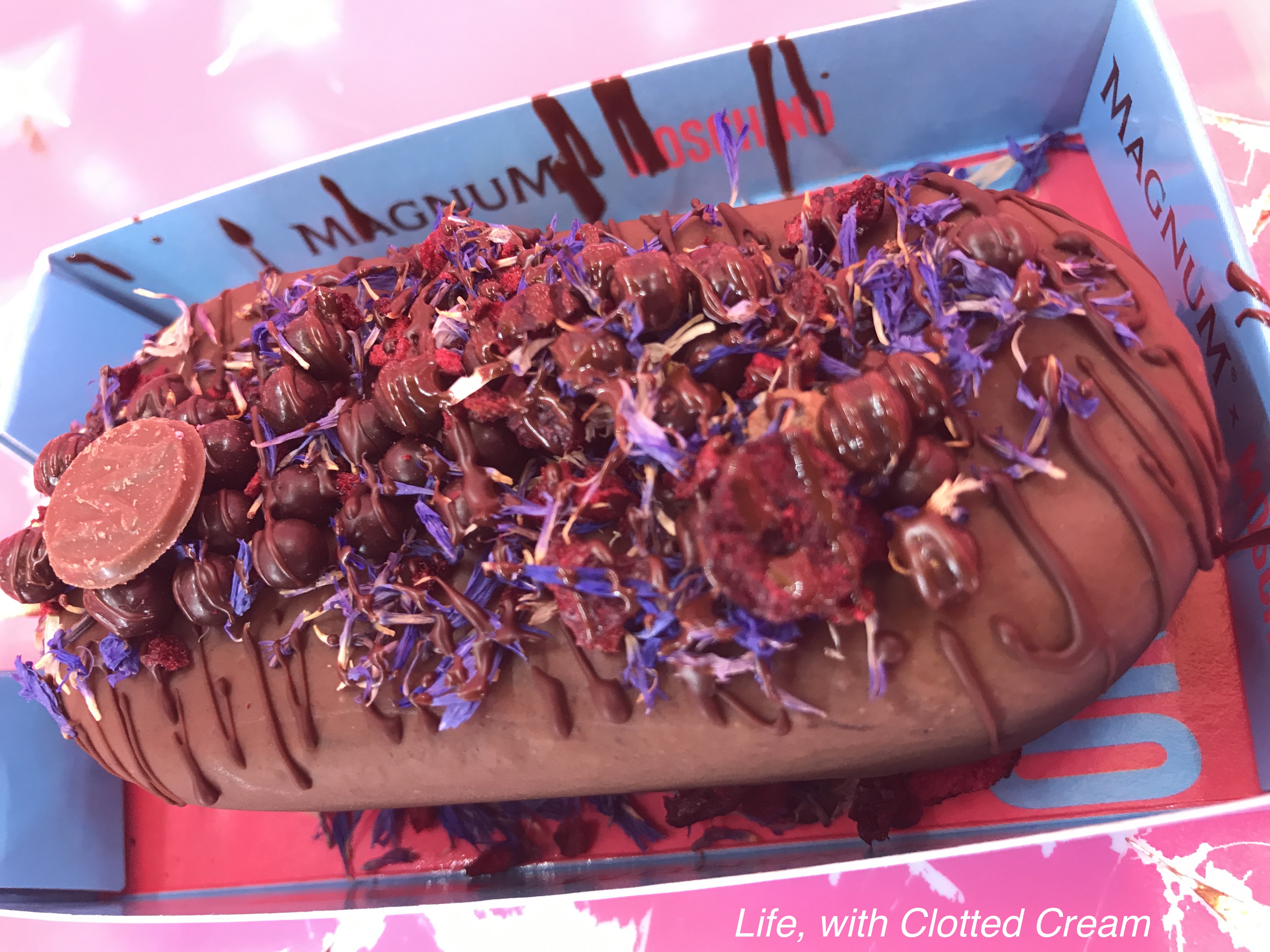 Magnum Ice Cream with cherries, chocolate pearls and corn flower petals